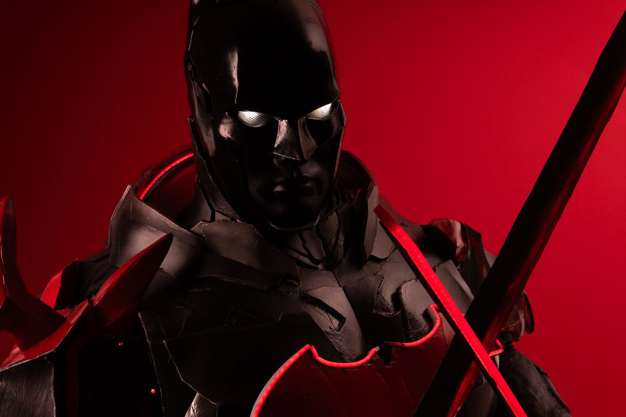 striking cosplay portrait featuring a character in black and red armor