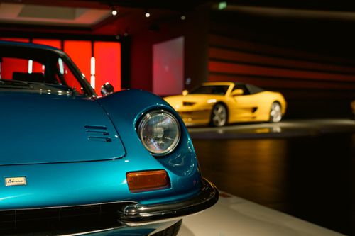 Free Close-up of vintage and modern sports cars in a sleek, well-lit showroom. Stock Photo