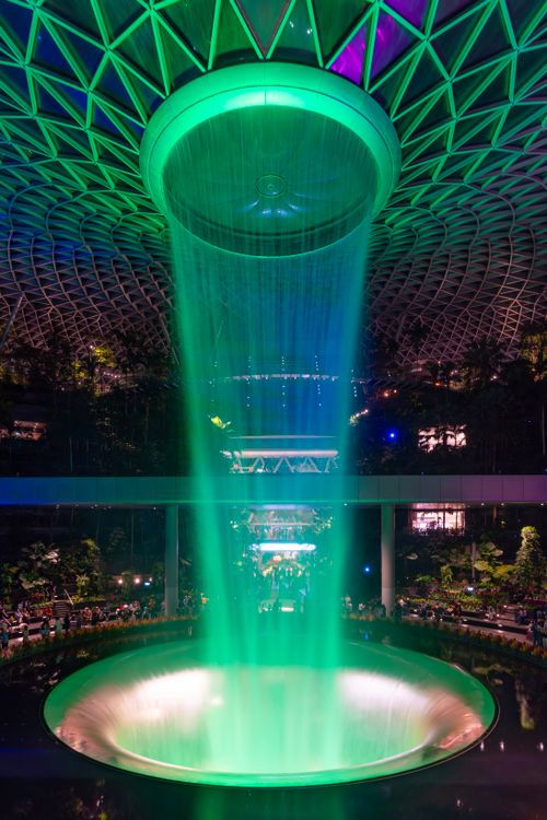Free Breathtaking view of the Jewel Changi Airport's indoor waterfall lit with vibrant colors, Singapore. Stock Photo