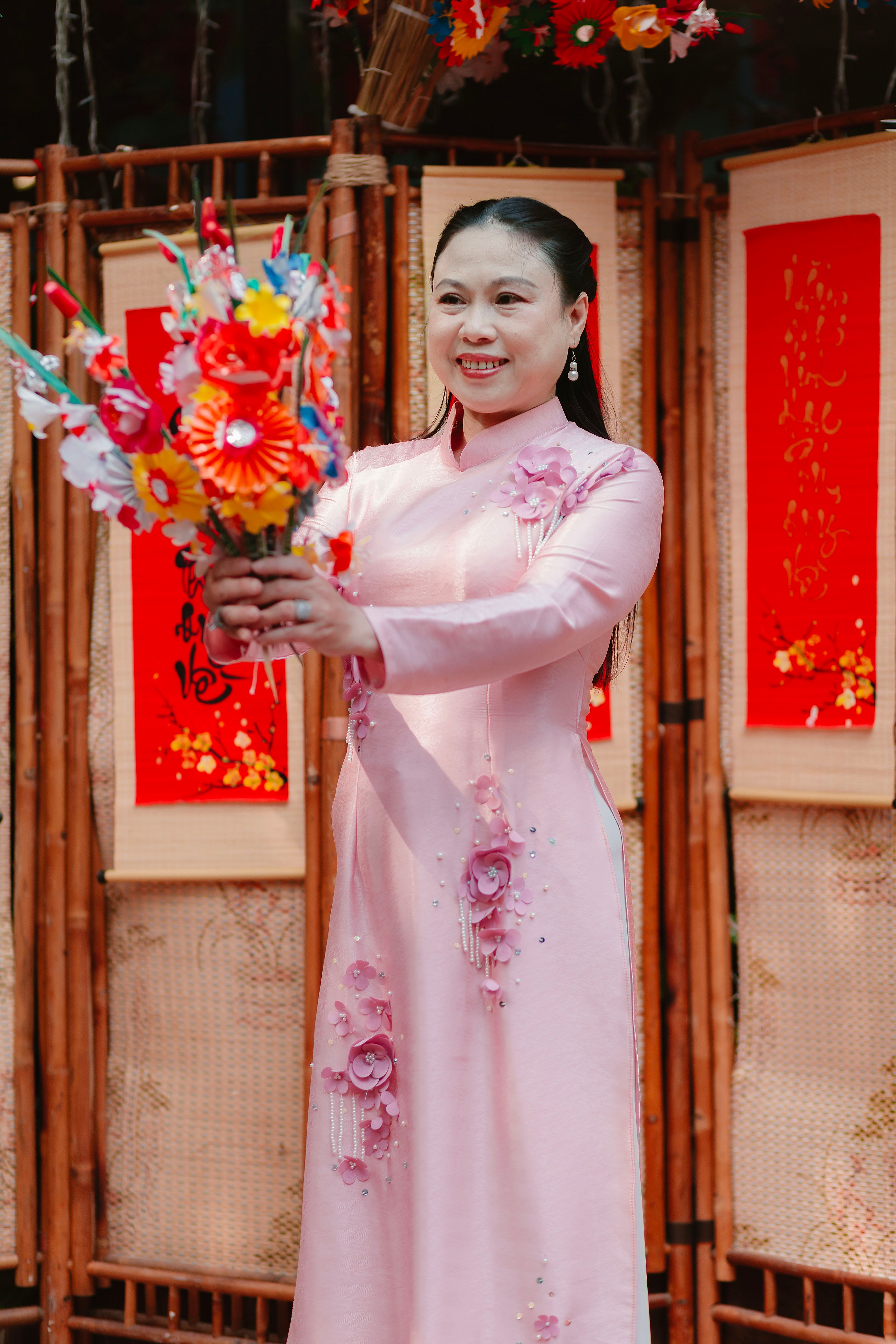 Woman in Pink Dress Holding Colorful Paper Flowers · Free Stock Photo