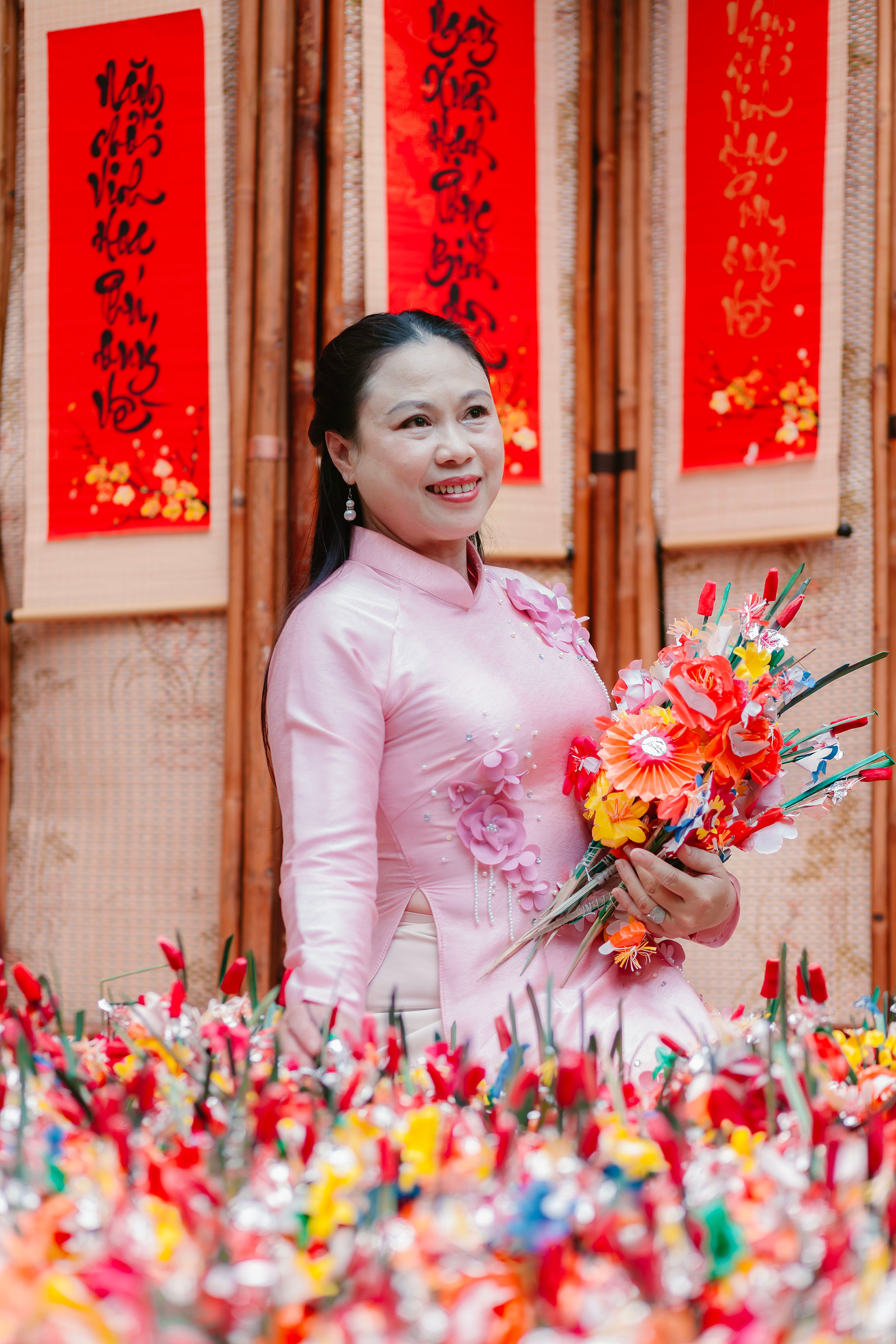 Smiling Woman in Traditional Dress with Flowers · Free Stock Photo