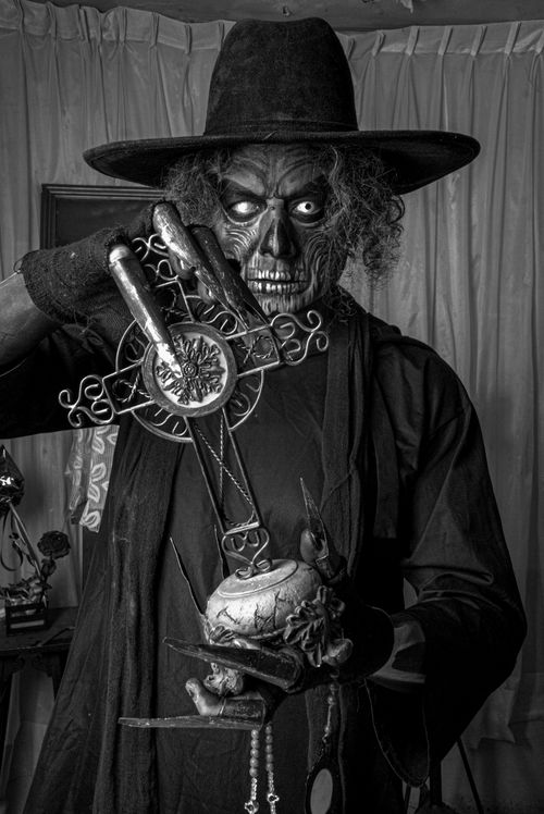 Free Black and white image of a sinister figure holding a mystical object, creating an eerie atmosphere. Stock Photo