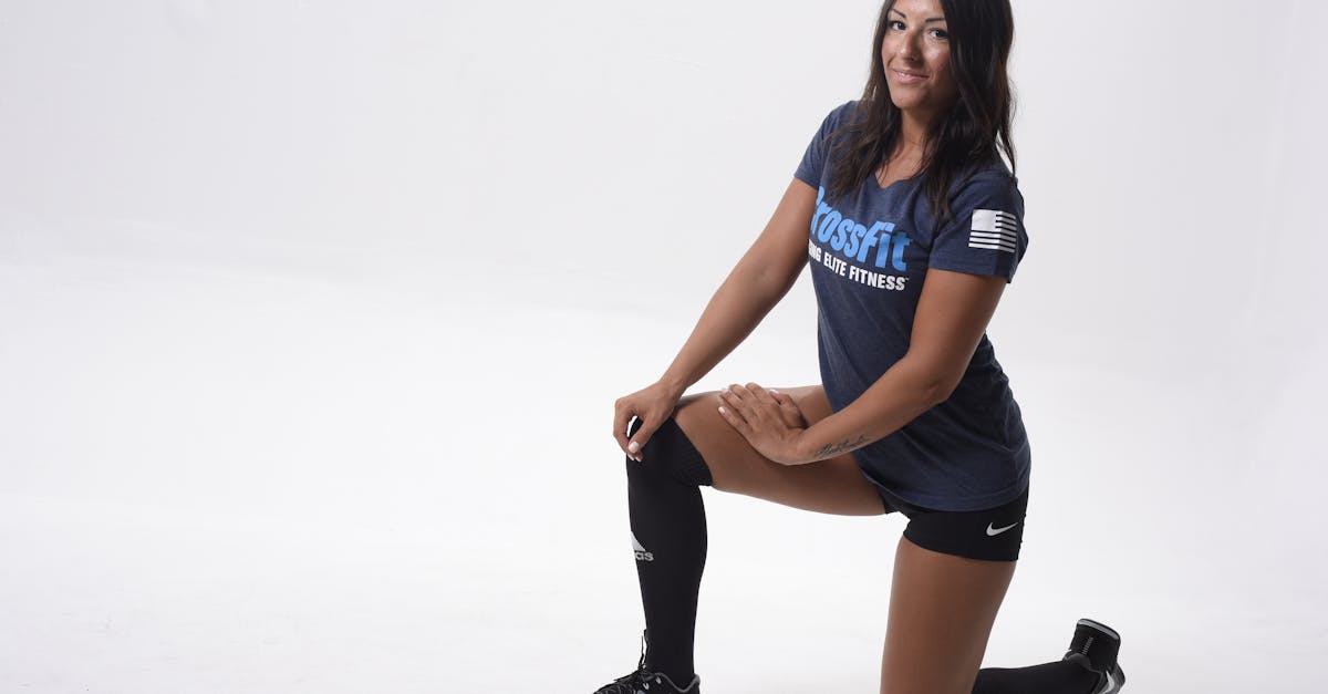 Athlete kneeling in studio promoting CrossFit. Focus on fitness and strength.