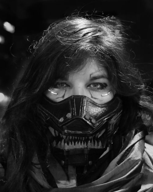 Free Black and white portrait of a woman wearing a futuristic mask, exuding mystery and intrigue. Stock Photo