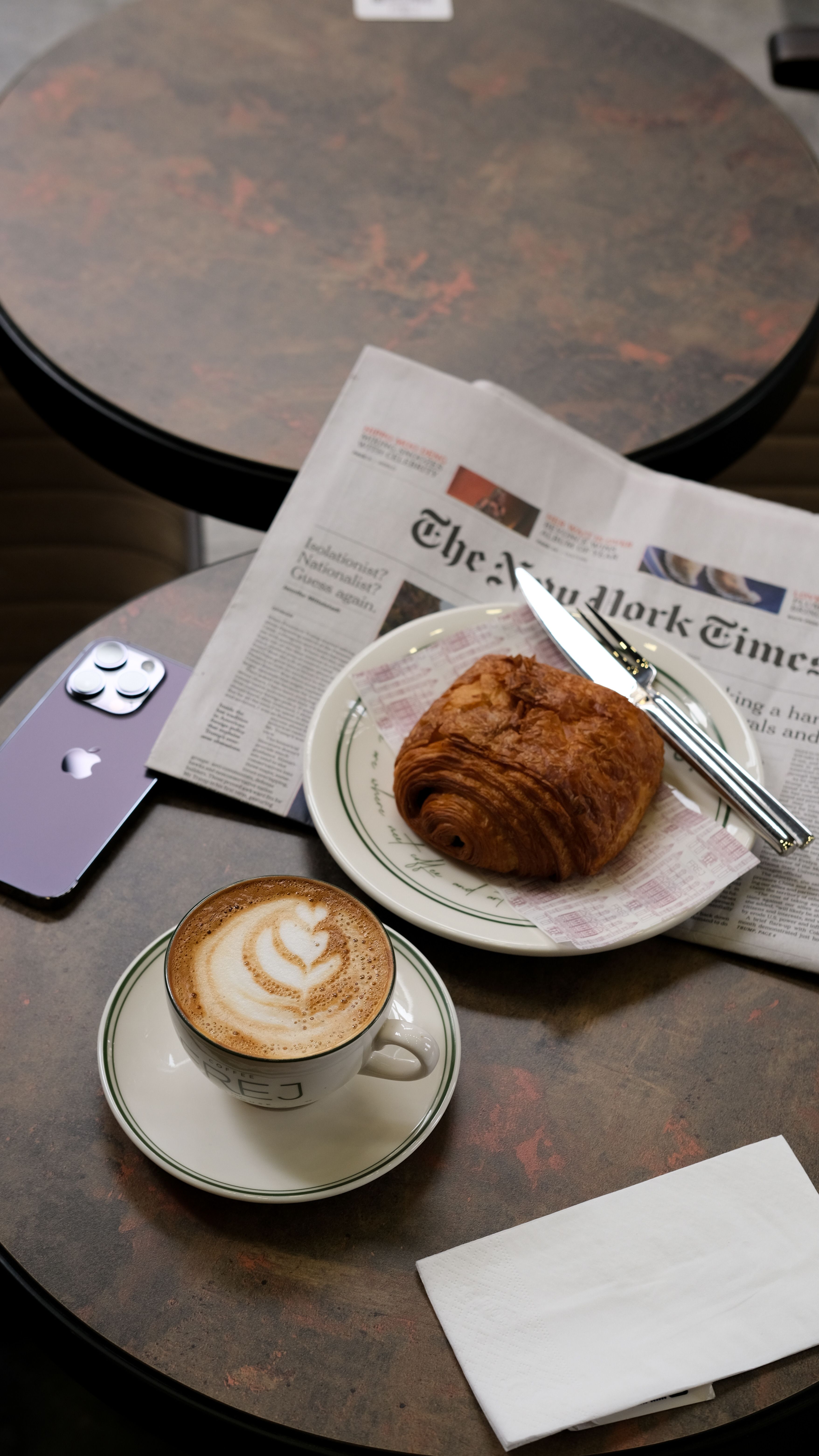 Coffee and pastry on an outdoor cafe table in a downtown Las Vegas neighborhood setting, representing the kind of walkable amenity French Riviera Tropezienne Bakery will bring to 401 S. Sixth Street