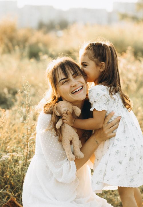 Free Heartwarming moment with mother and daughter in sunny field. Stock Photo