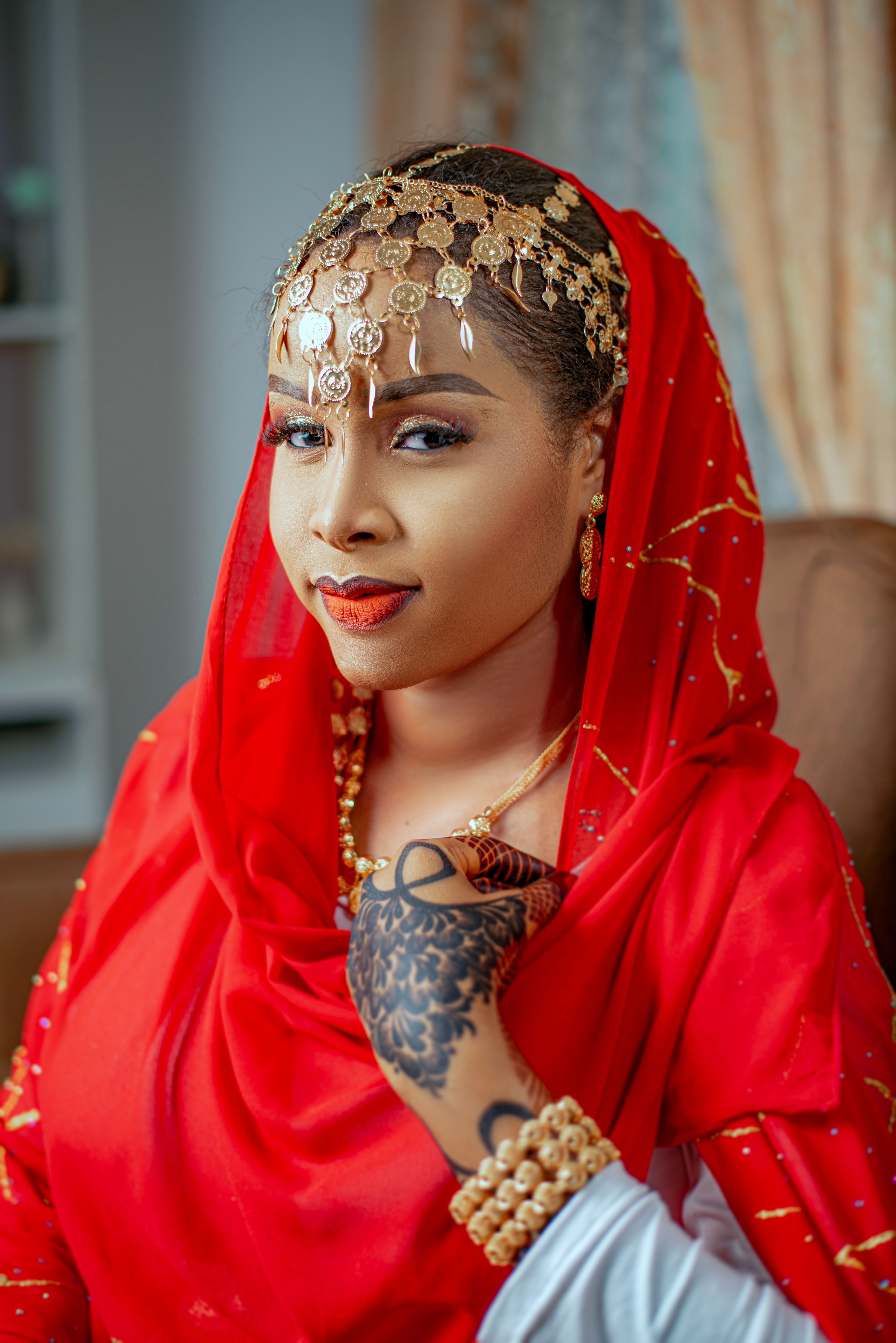 Elegant Woman in Traditional Red Attire Indoors · Free Stock Photo