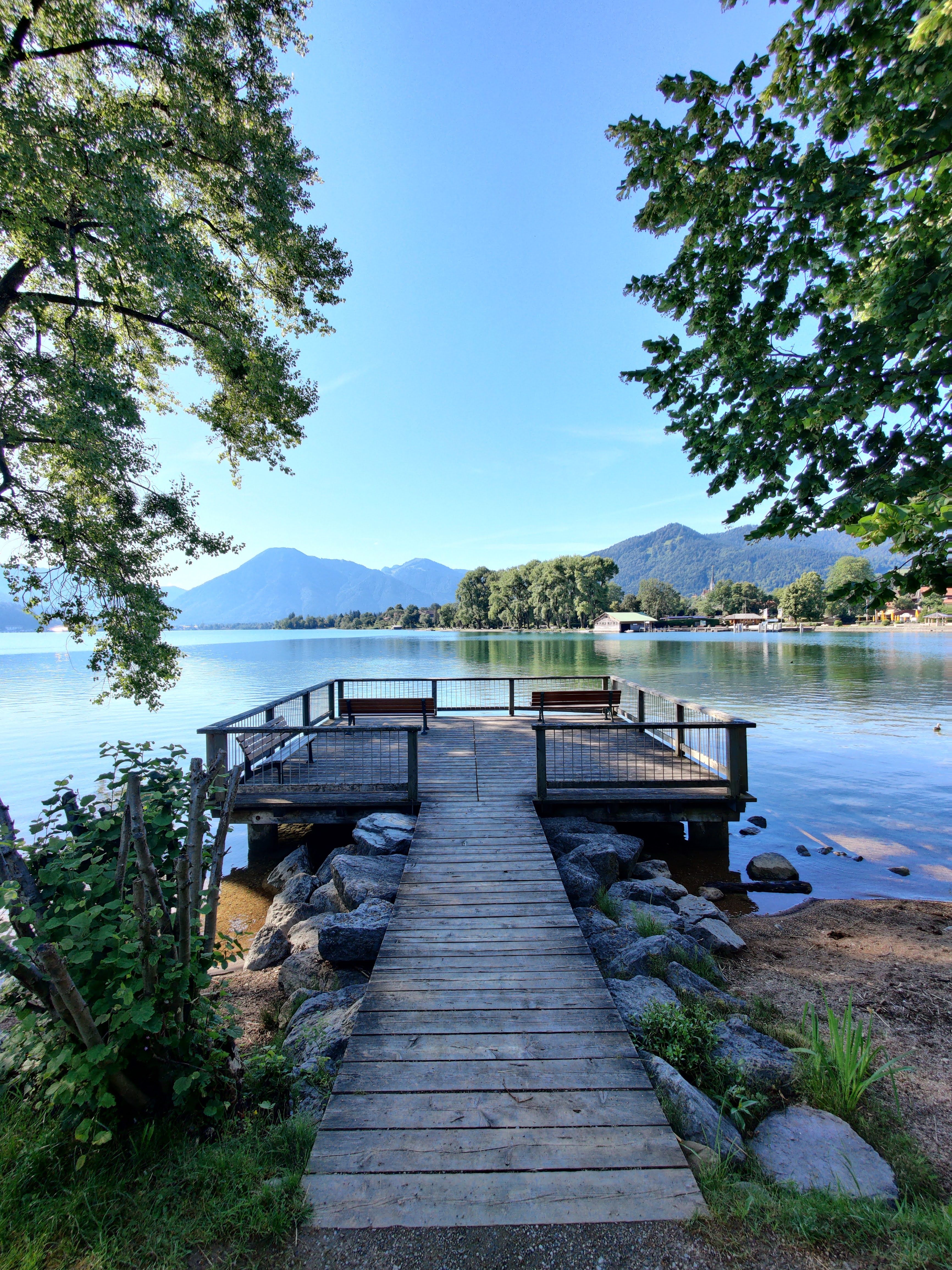 Serene Lakeside View with Wooden Dock and Mountain · Free Stock Photo