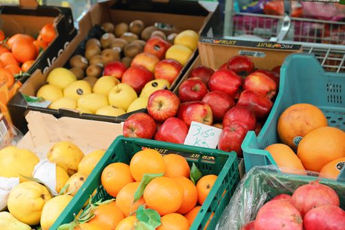 Free A vibrant display of fruits including apples, oranges, and lemons at a market in Eschwege, Germany. Stock Photo