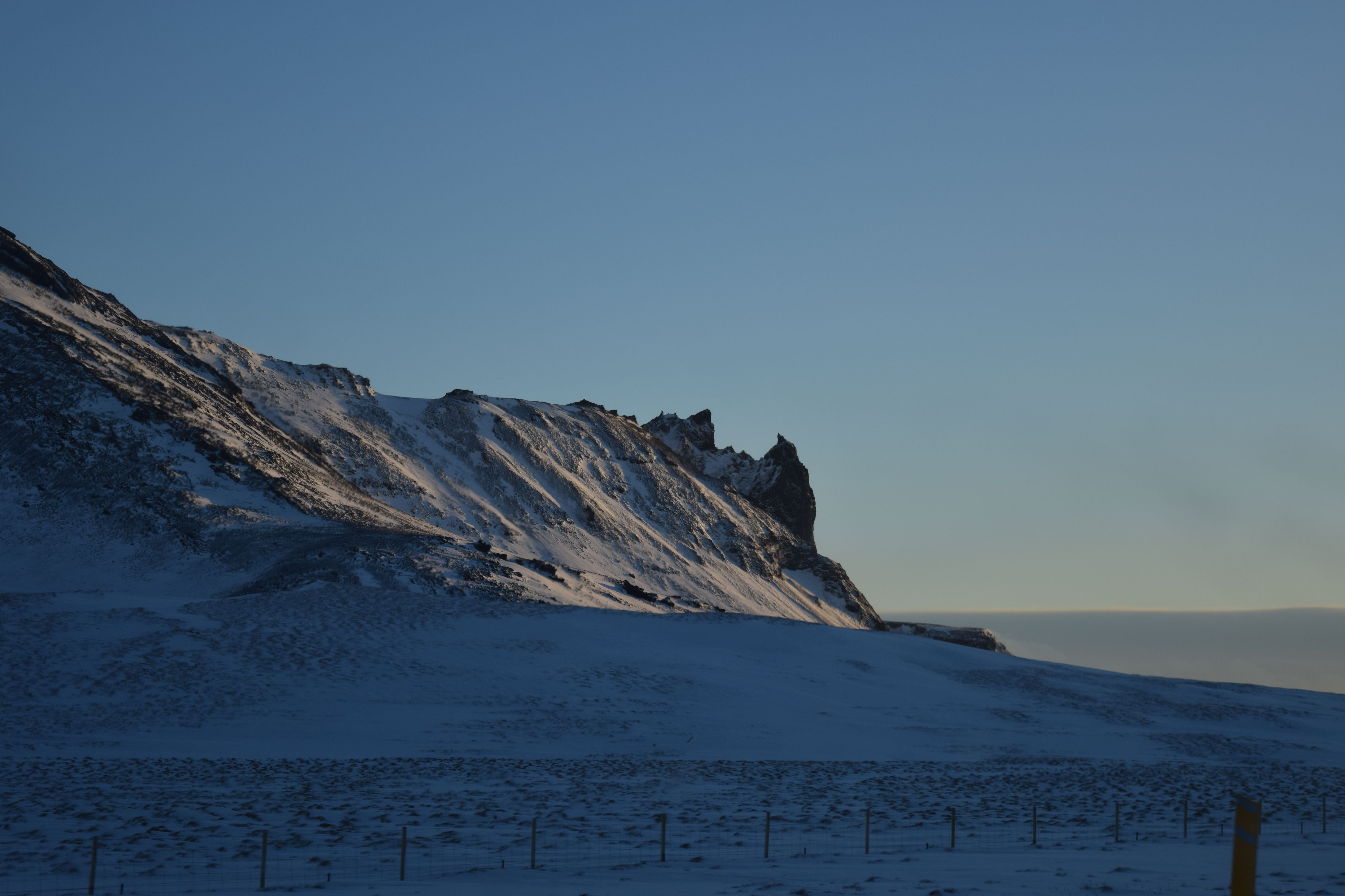 Snow-Covered Rocky Ridge at Dawn · Free Stock Photo
