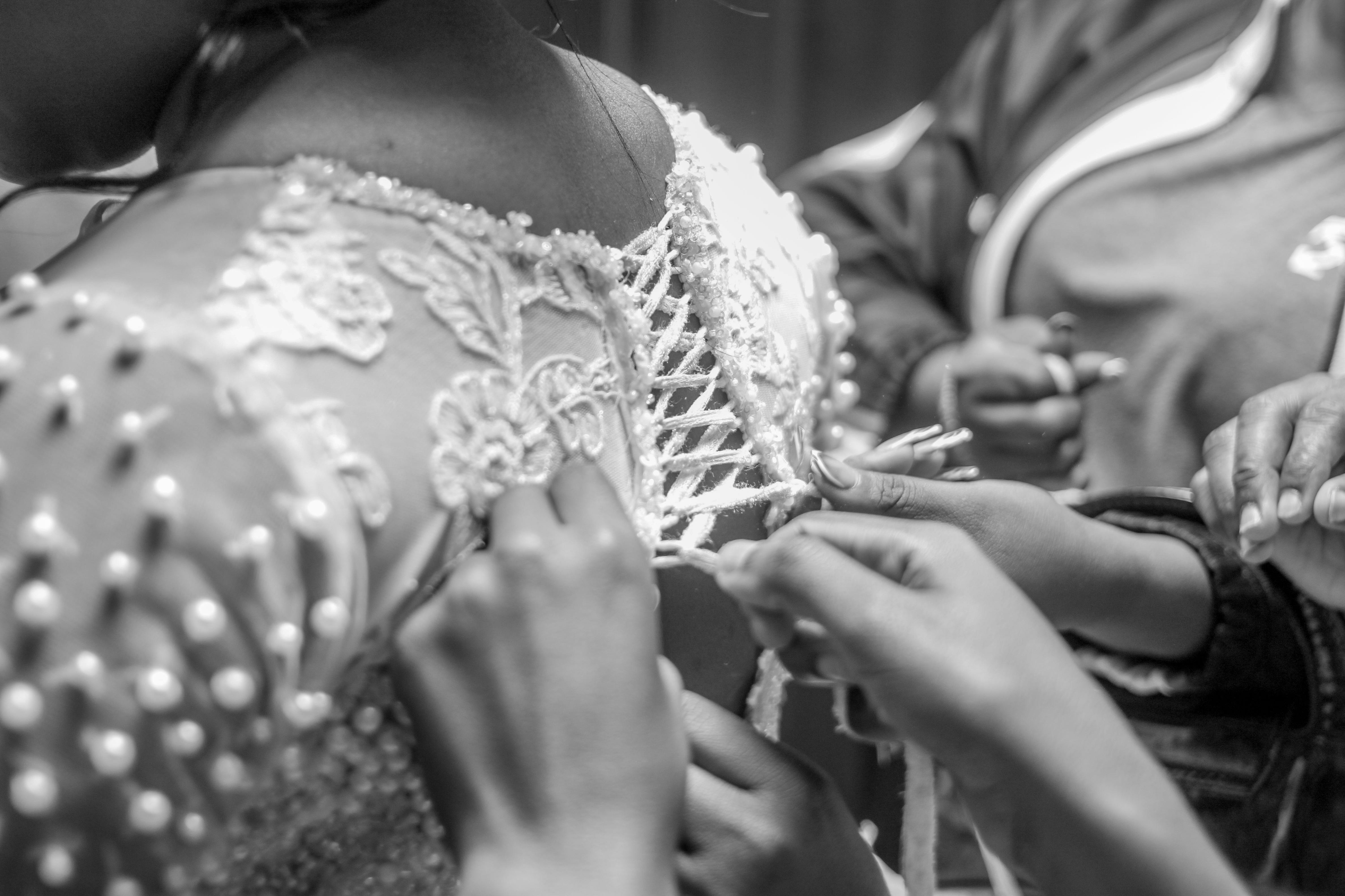 https://www.pexels.com/photo/black-and-white-closeup-of-bridal-gown-fitting-30575394/