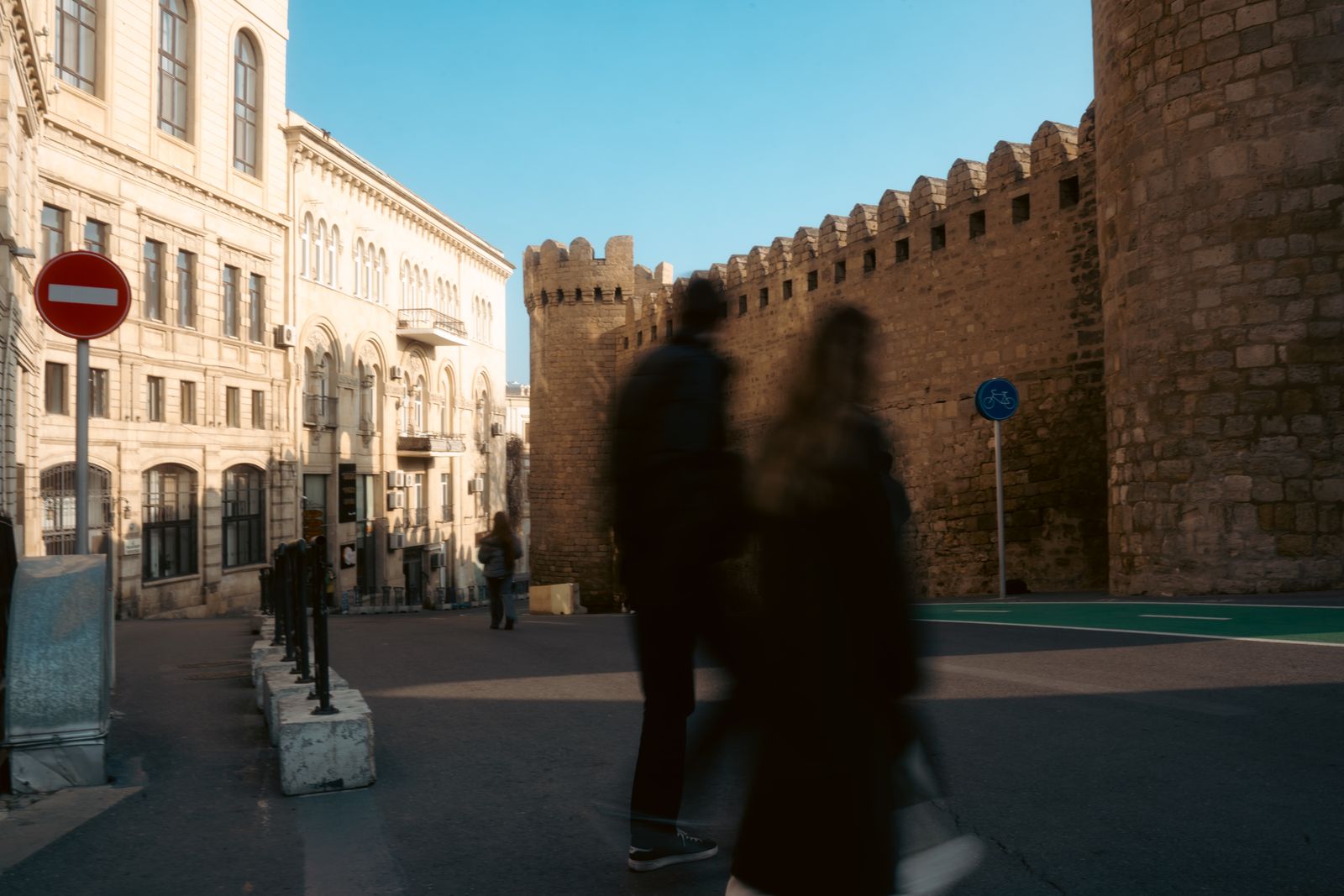 People passing the Old City walls in Baku