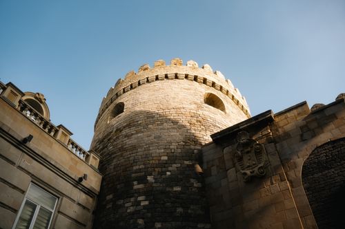 Free A historic stone tower in Baku, showcasing ancient architecture under a clear blue sky. Stock Photo