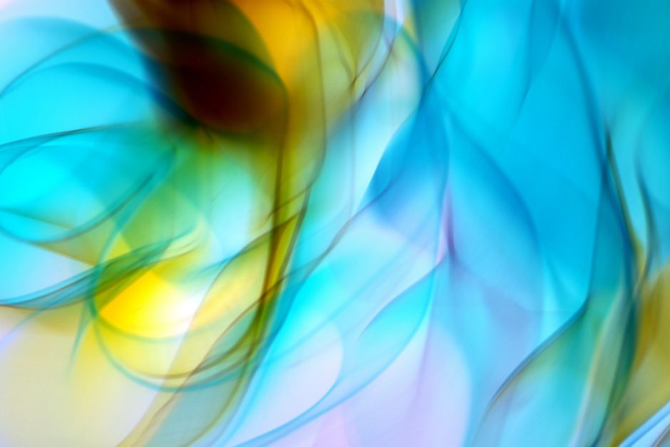 Vivid abstract design with flowing blue and yellow curves and light patterns.