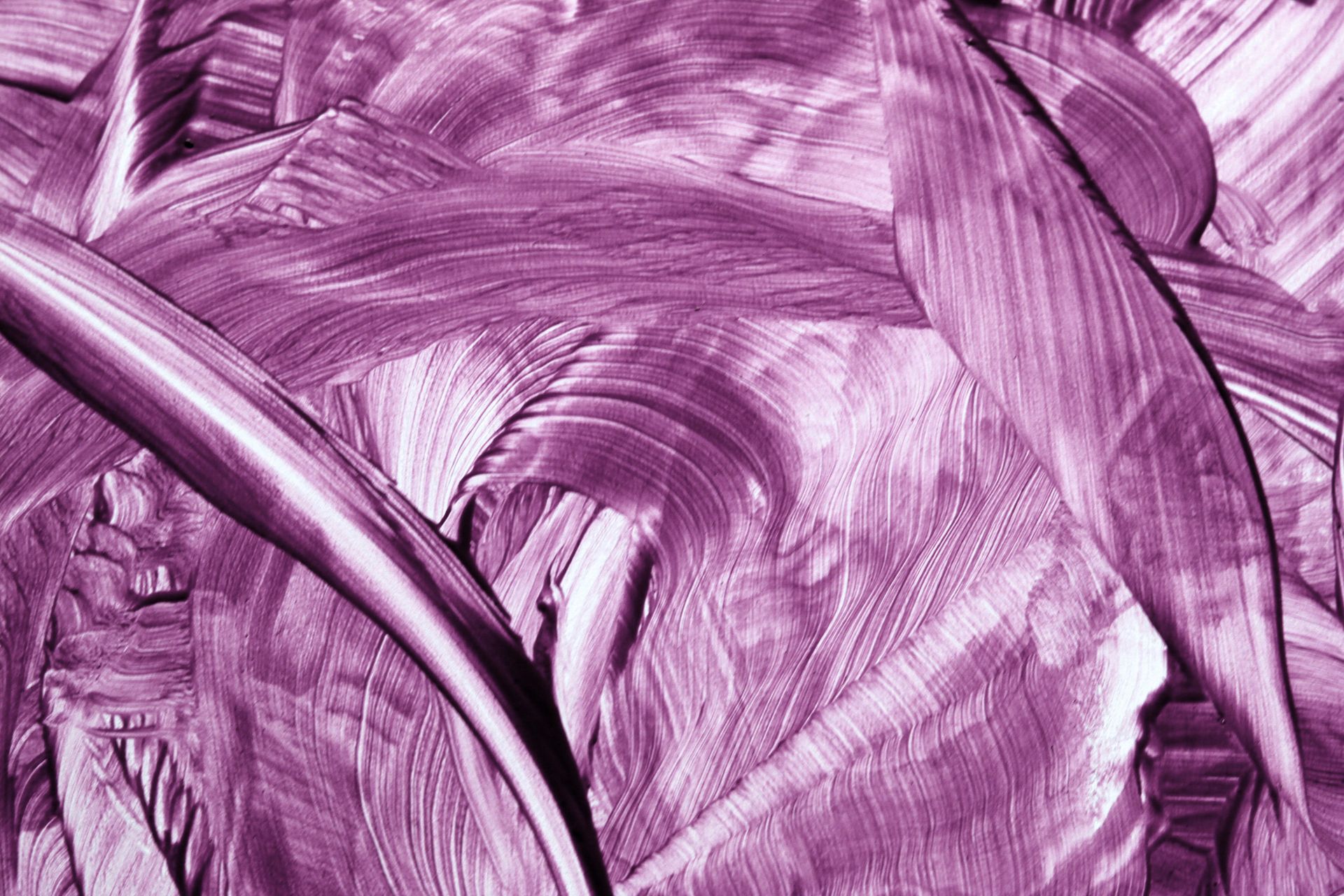 Close-up of swirling purple brush strokes creating a textured abstract pattern.