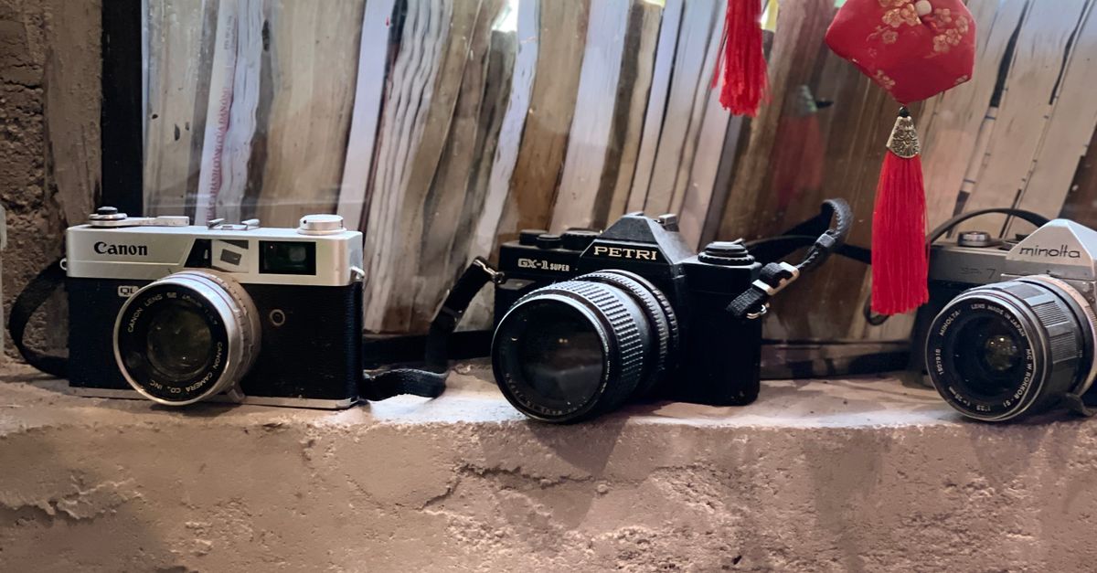 Vintage Cameras Displayed on Rustic Shelf · Free Stock Photo