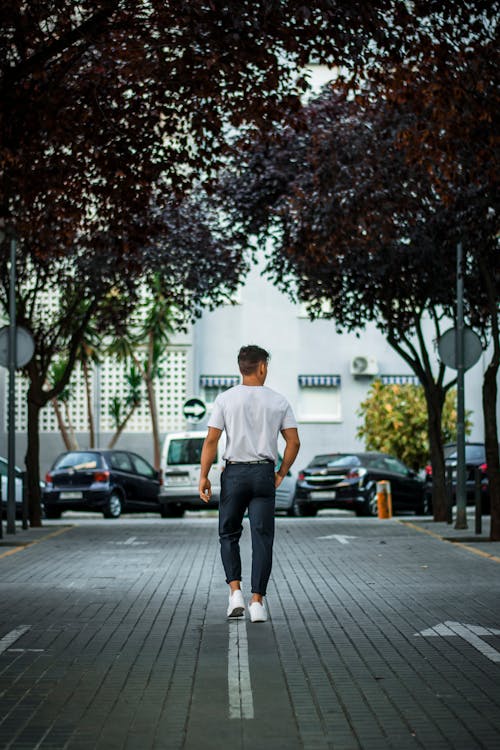 Man Wears White T-shirt and Black Pants