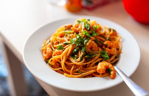 Free Close-up of shrimp spaghetti with parsley, perfect for a healthy Mediterranean meal. Stock Photo