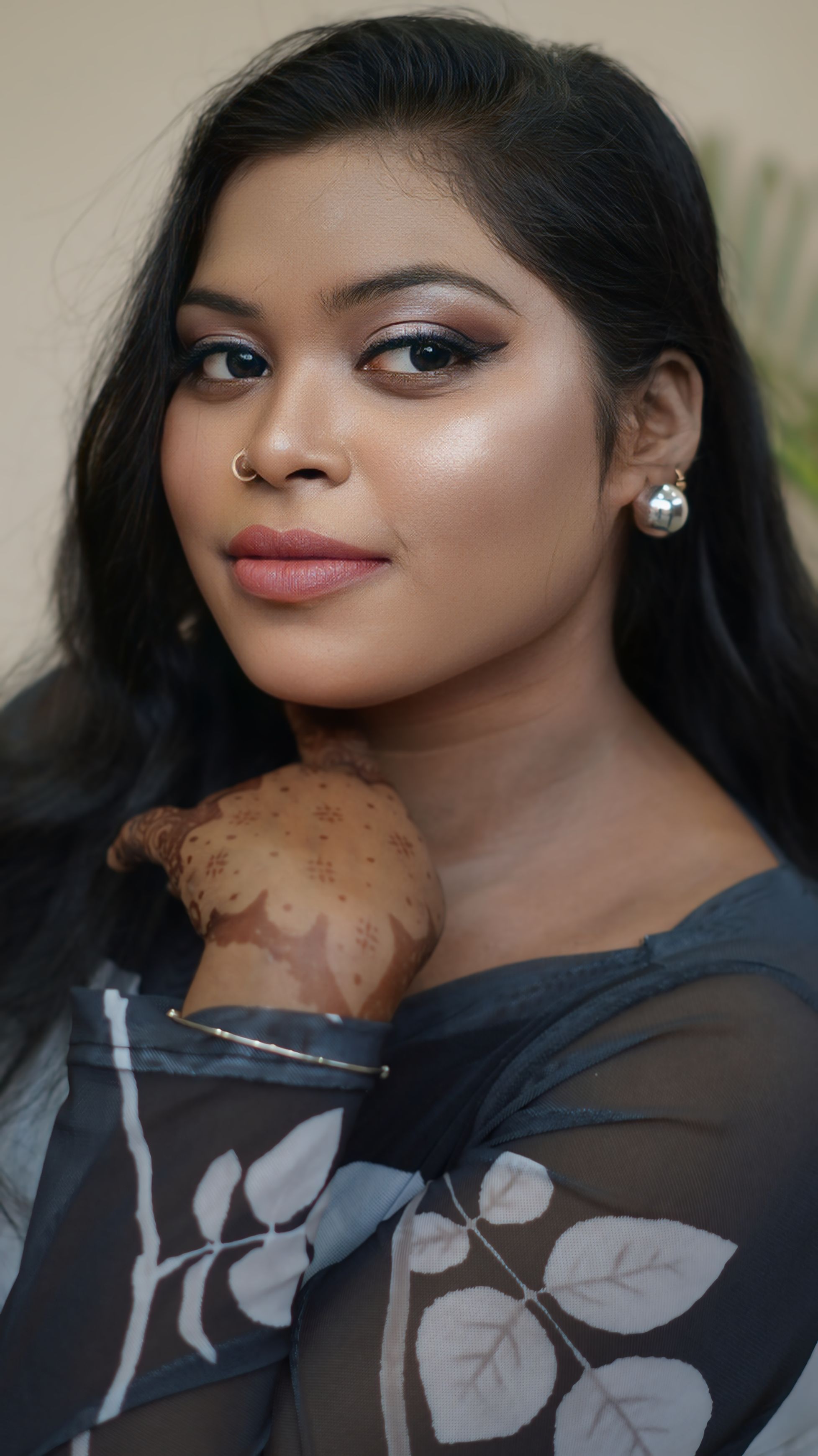Portrait of a South Asian woman with henna art and elegant makeup, capturing beauty and tradition.