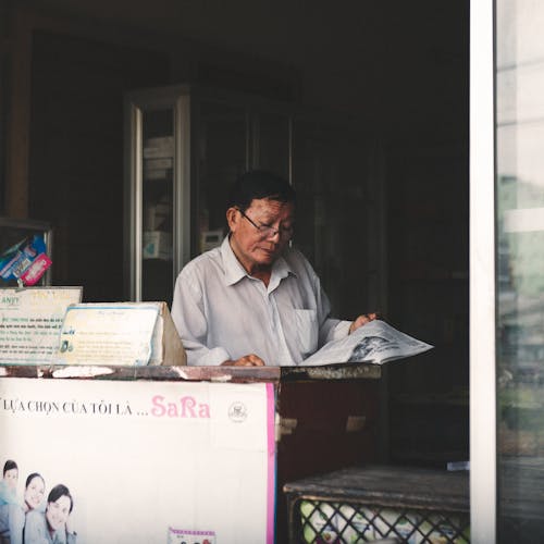 Free Asian Man Reading Newspaper Stock Photo