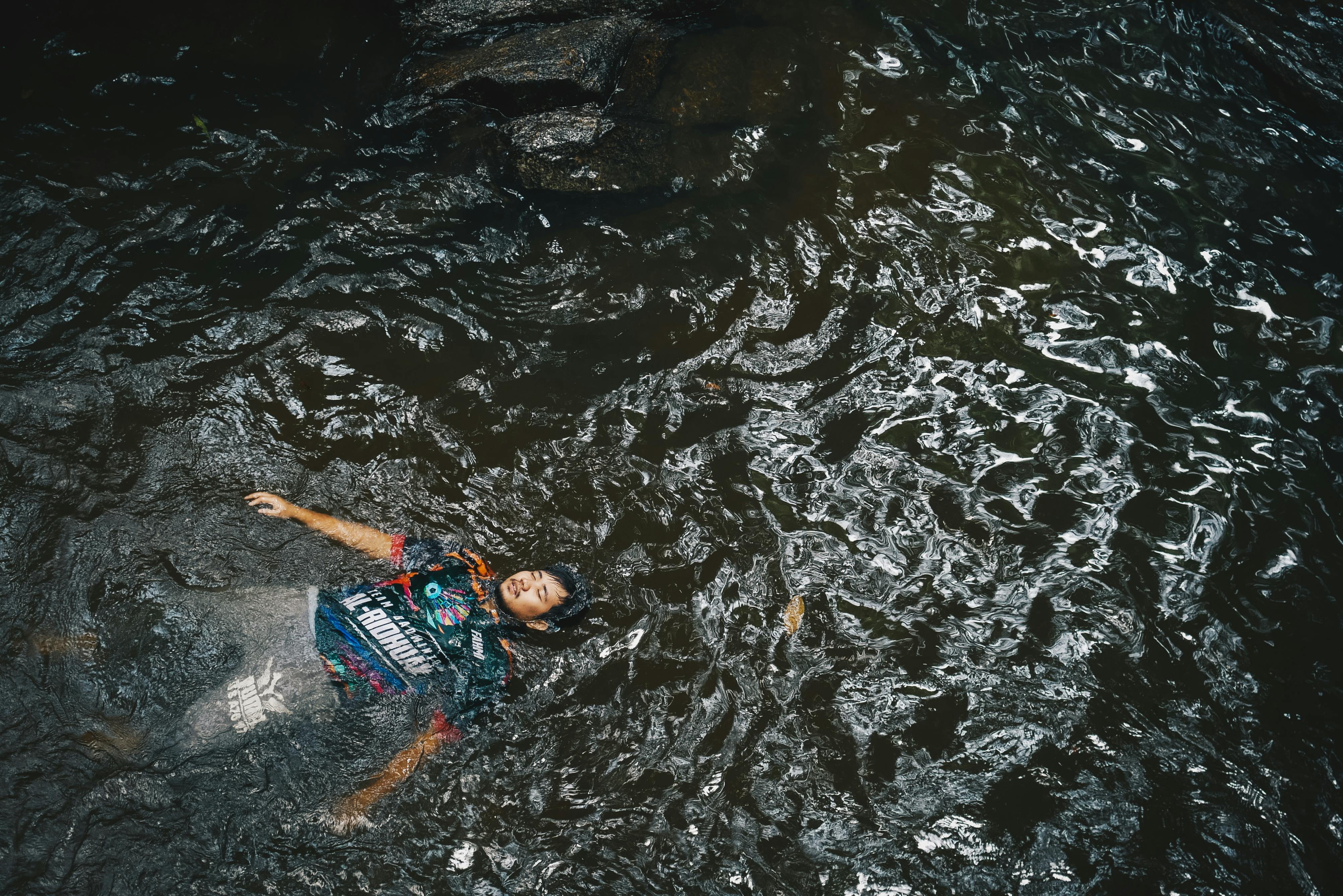 HighAngle Photo of Man Floating on Water · Free Stock Photo