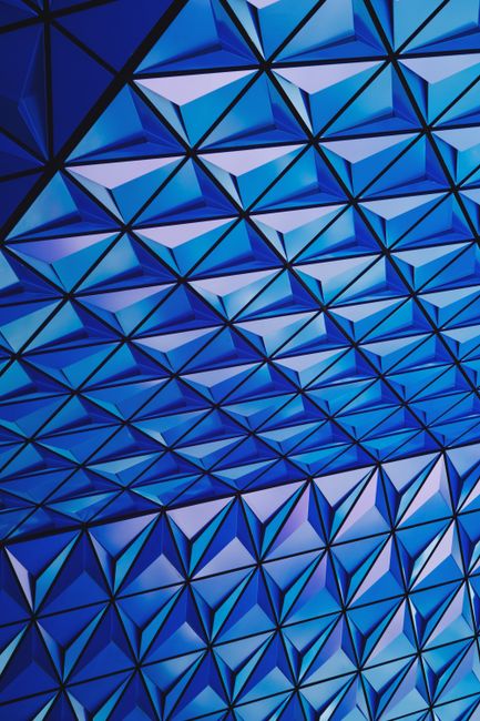 Vibrant blue geometric pattern with interlocking triangles for modern design.