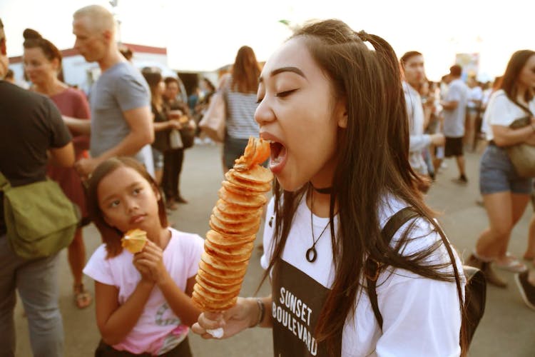 Girl Eating Skewer Food