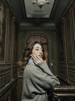 Woman in a vintage hallway, Baku, exudes classic style with dark, moody tones. Captivating setting and ambiance.