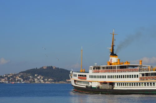 Free A classic ferry sails on the Bosphorus against the backdrop of Istanbul's landscape. Stock Photo