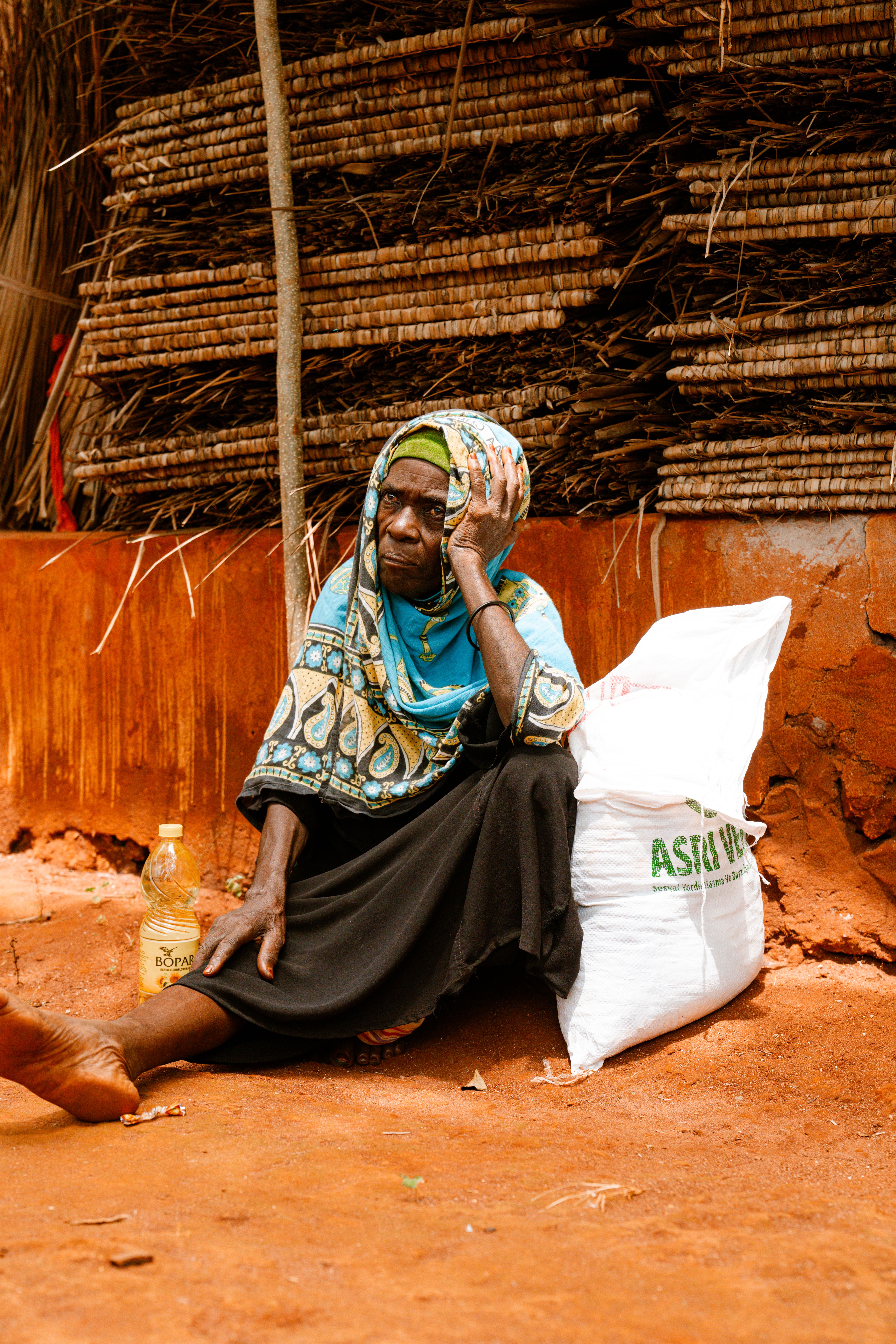 Elderly Woman Resting in Rural Setting · Free Stock Photo
