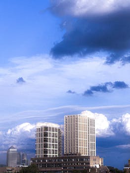A view of high-rise buildings in London with dramatic clouds in the sky.