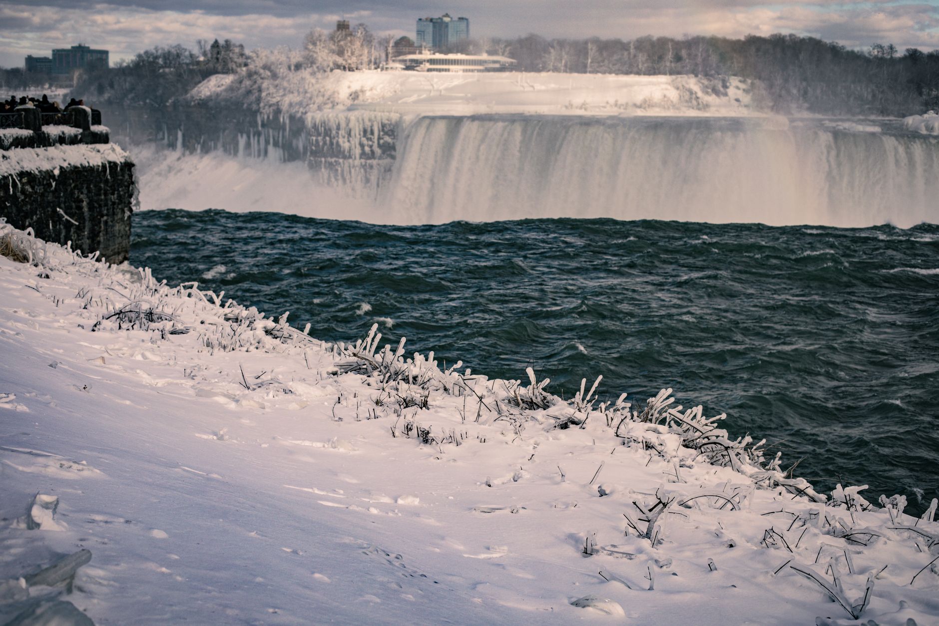 A snowy and icy winter view of Niagara Falls captured from Ontario, Canada.