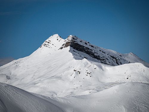 Free Stunning snow-covered mountain peak in Davos, Switzerland under a clear blue sky. Stock Photo