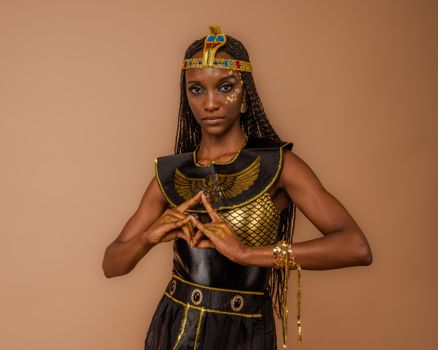 Creative portrait of a model in Egyptian-inspired attire exuding elegance.