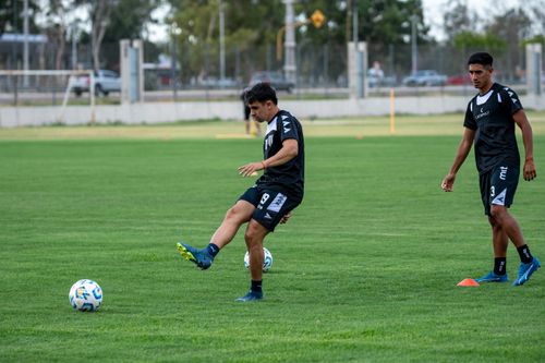 Free Young athletes practicing soccer skills on a sunny day outdoors. Stock Photo