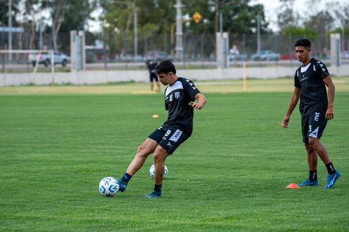 Free Two soccer players practicing on a green field, focusing on team training. Stock Photo