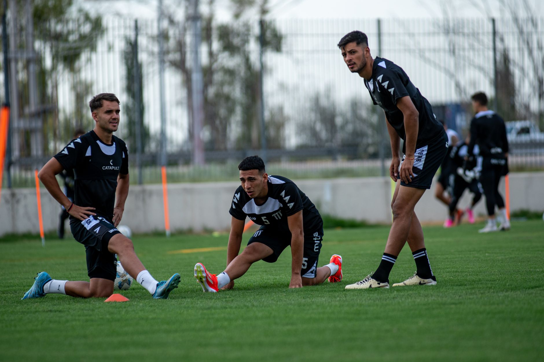 a national team training session showing a winger, full-back, and midfielder rehearsing coordinated pressing