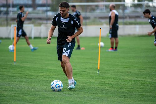 Free Soccer players training on a grass field, practicing dribbling skills. Stock Photo
