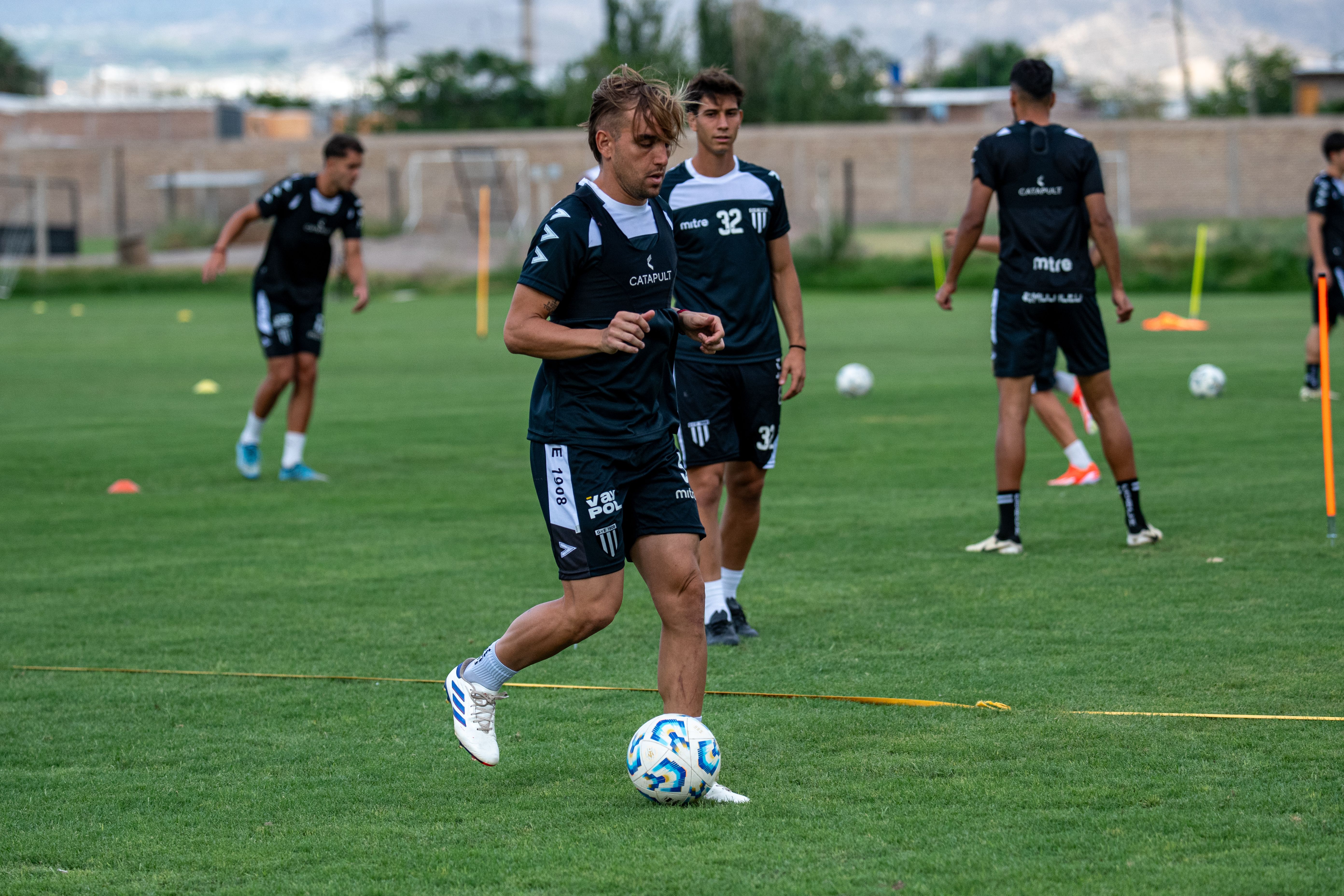 Professional football players training together on a field