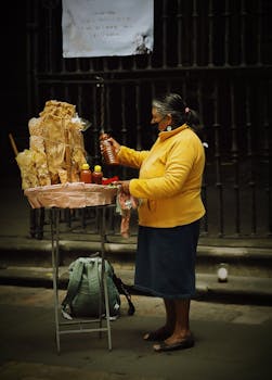 Elderly woman selling street snacks in Mexico City, showcasing local culture.