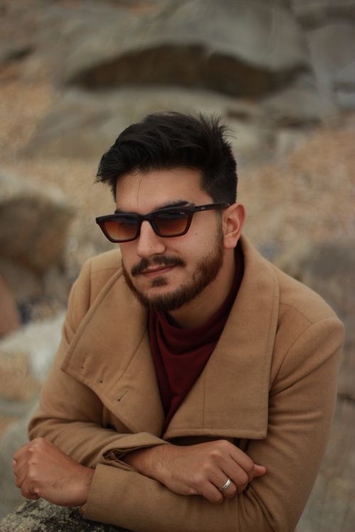 Free Chic outdoor portrait of a man wearing sunglasses in Porto, Portugal, showcasing a modern style. Stock Photo