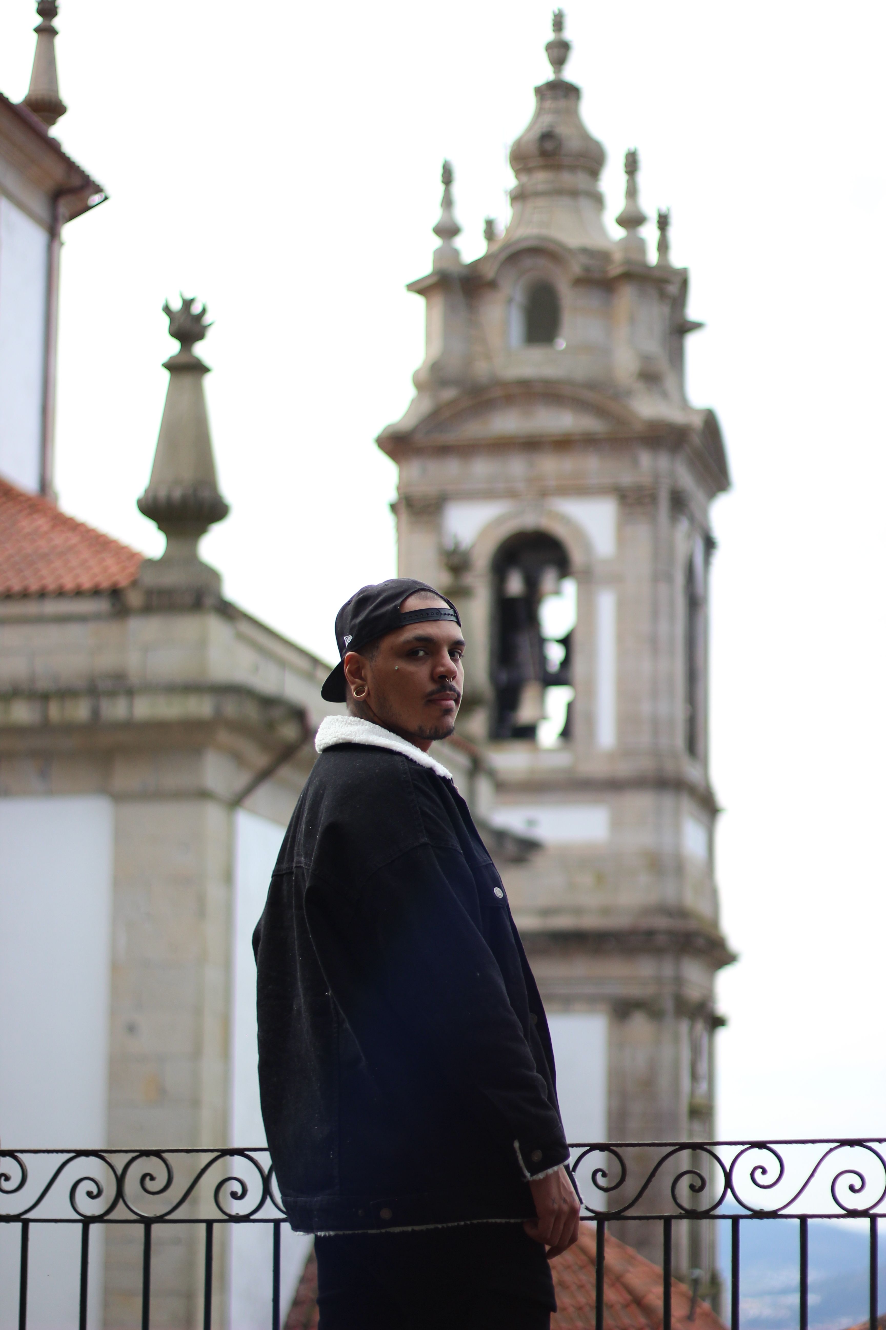 Young man poses against the backdrop of architectural landmarks in Braga.