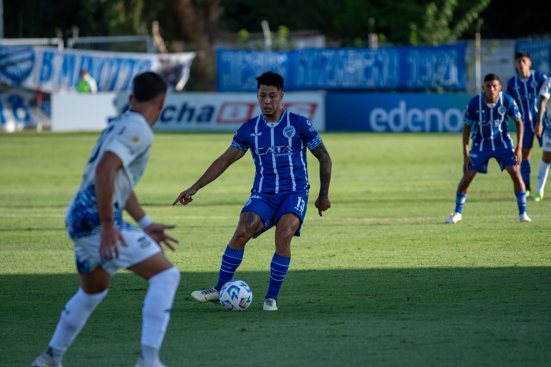Soccer players in action on a sunny sports field during an intense match.