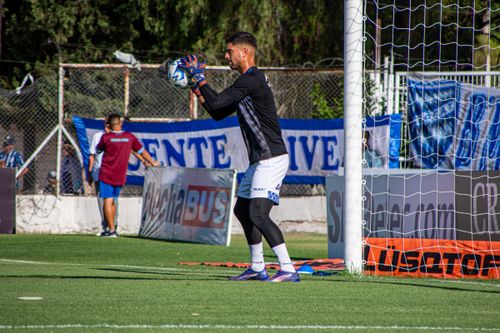 Free Soccer goalkeeper practicing with ball during daylight at outdoor field. Stock Photo