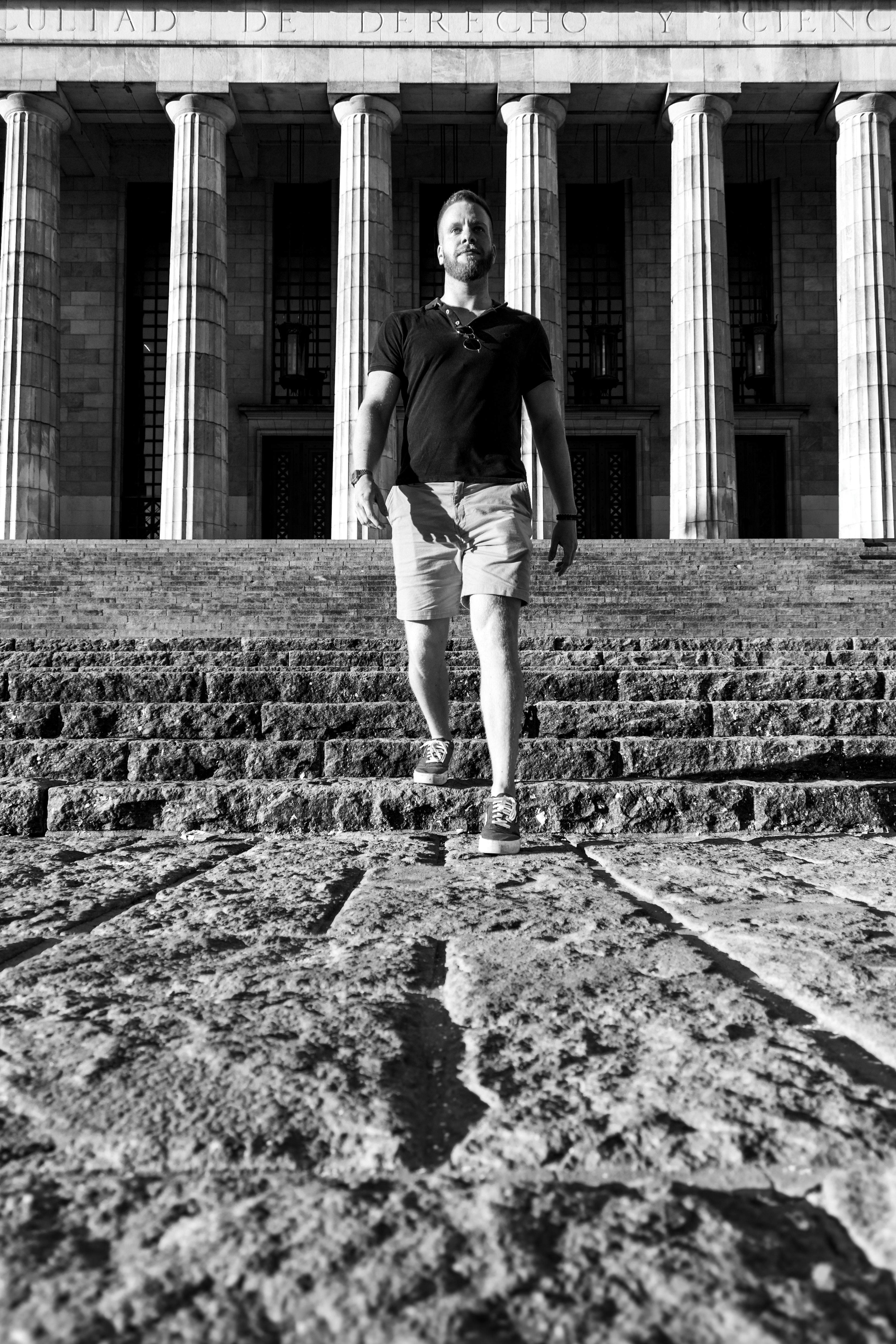 Black and white photo of a man descending steps at the University of Buenos Aires, Argentina.