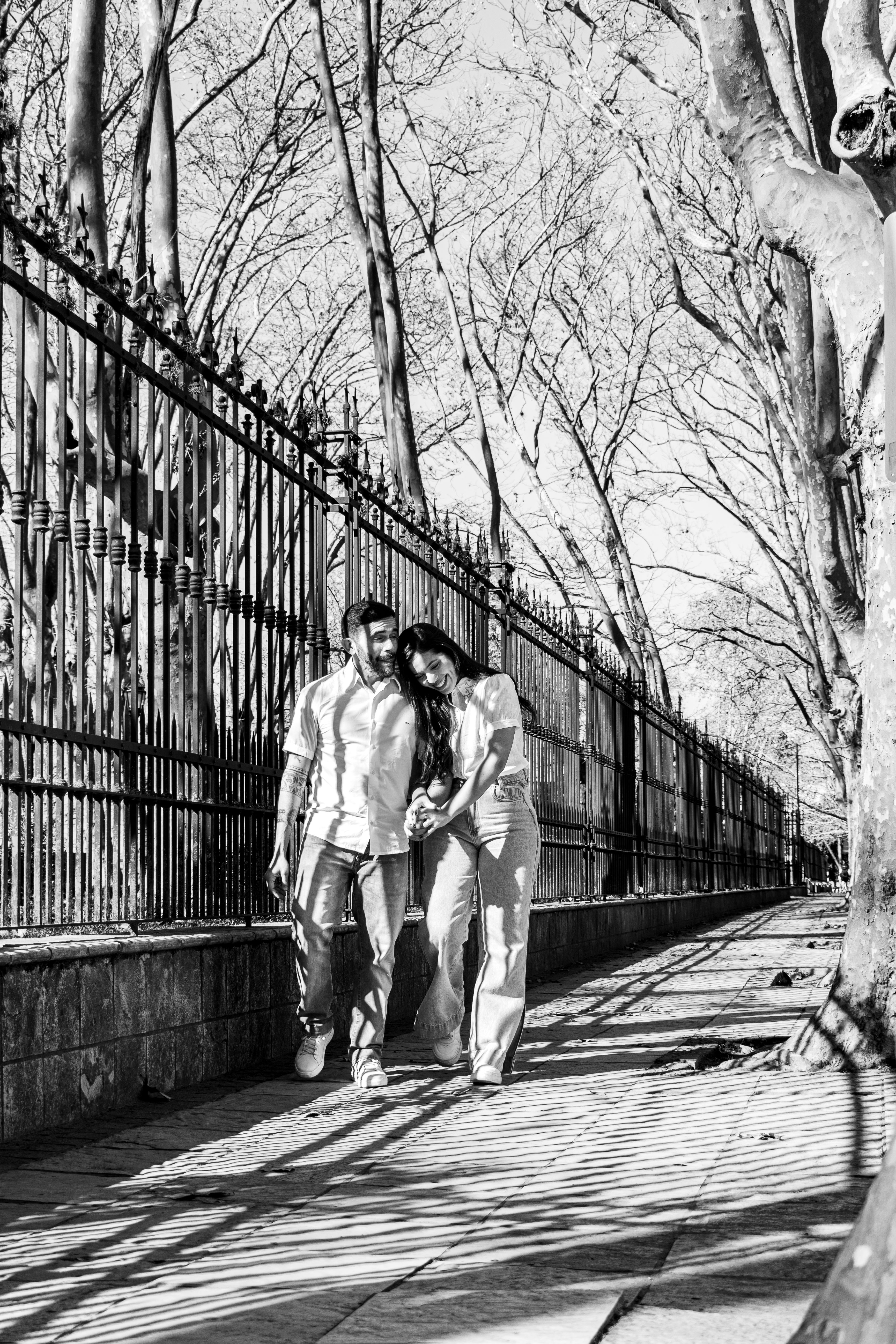A couple enjoying a romantic walk through a park in Buenos Aires, Argentina.