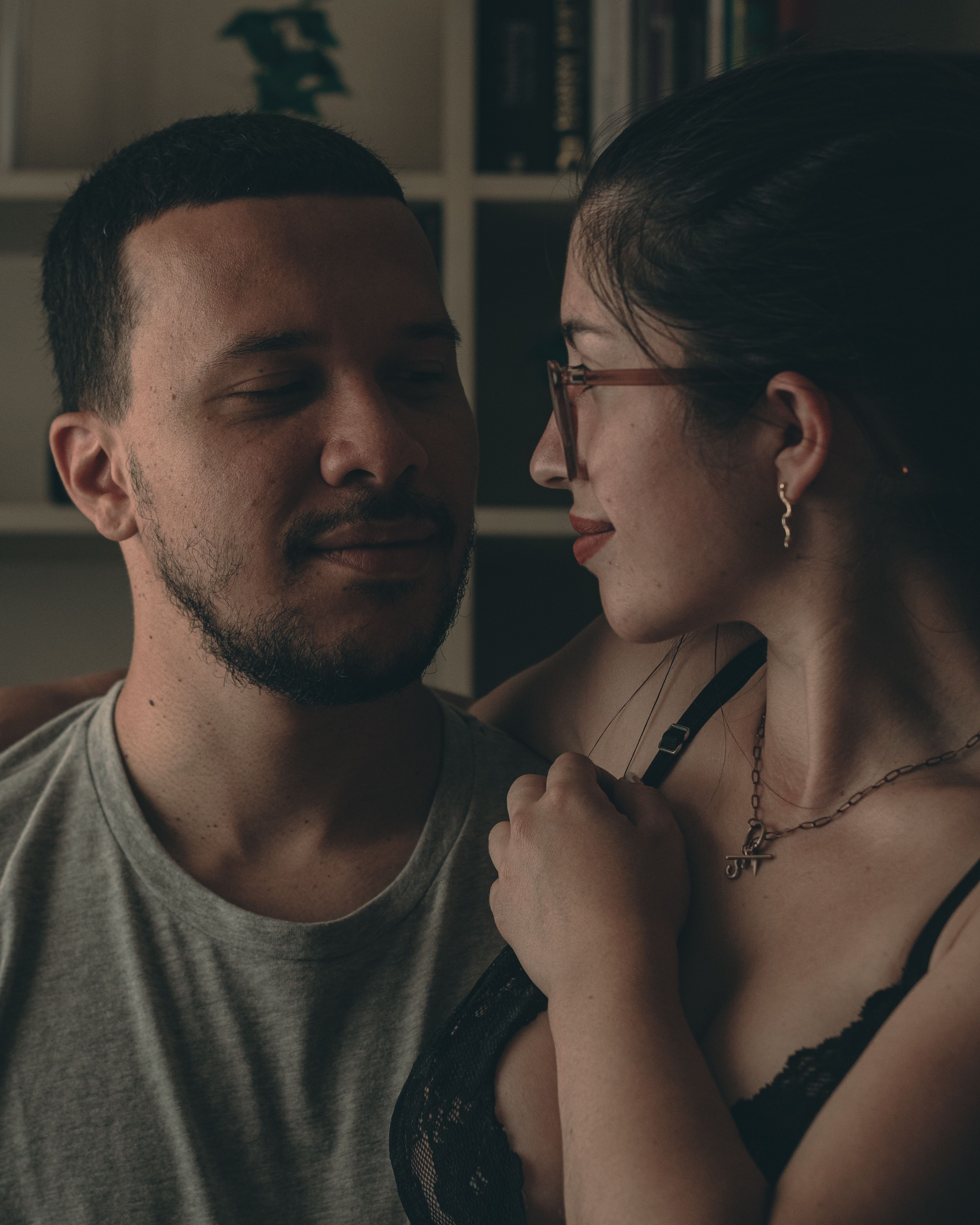 Intimate moment between a couple indoors, showcasing love and connection.