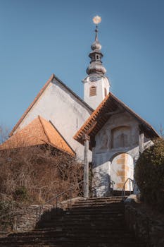 A picturesque historic church with classic European architecture under a clear blue sky.