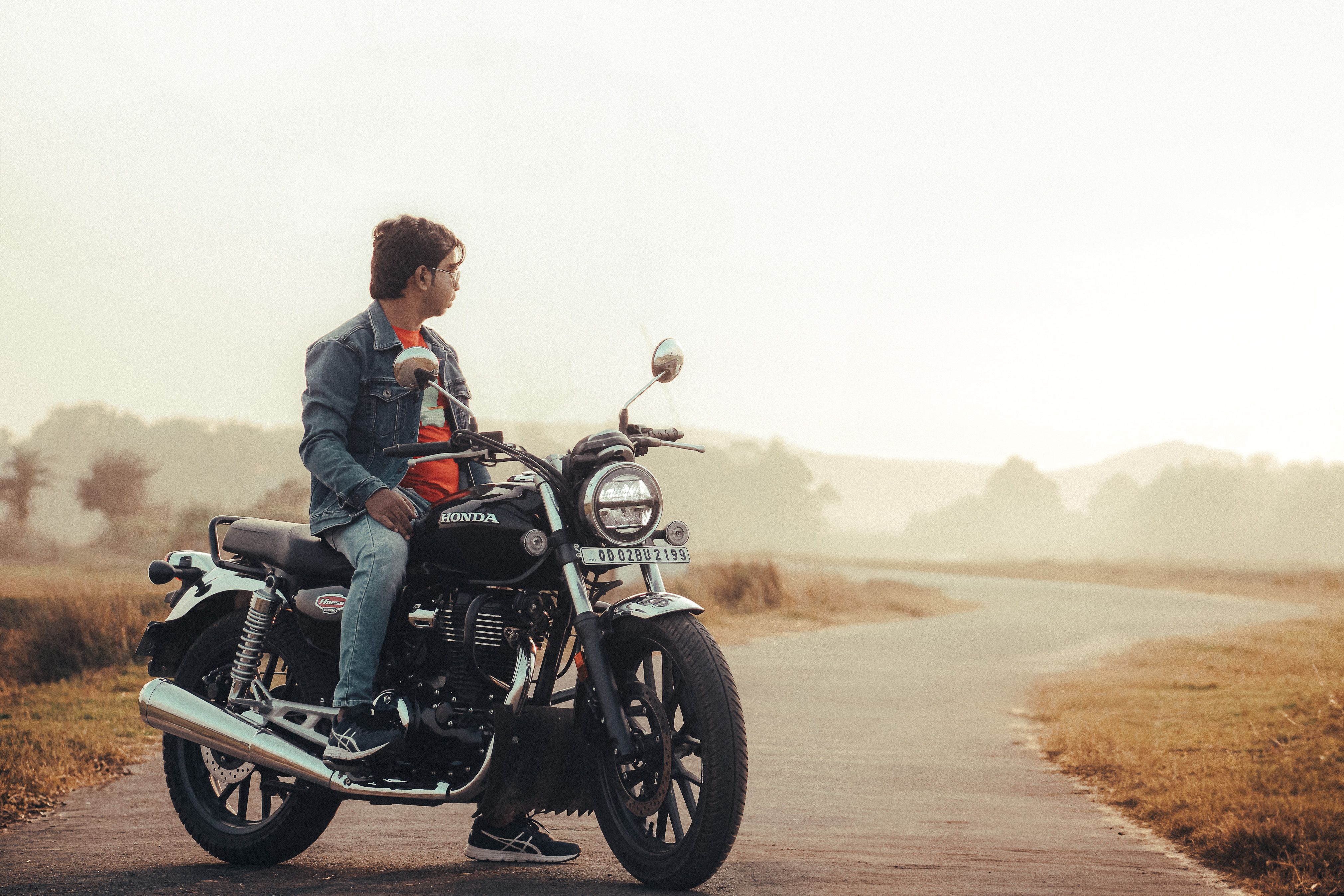 Man Riding Classic Motorcycle on Rural Road · Free Stock Photo