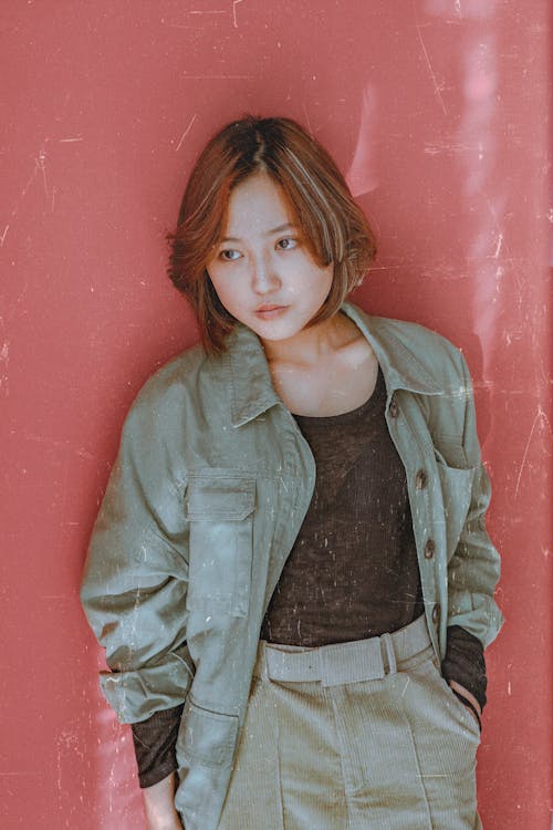 Photo Of Woman Leaning On Red Wall